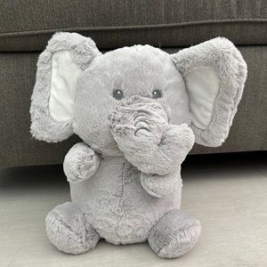 Grey fluffy elephant plushie. Has crinkly ears and makes a rattle noise